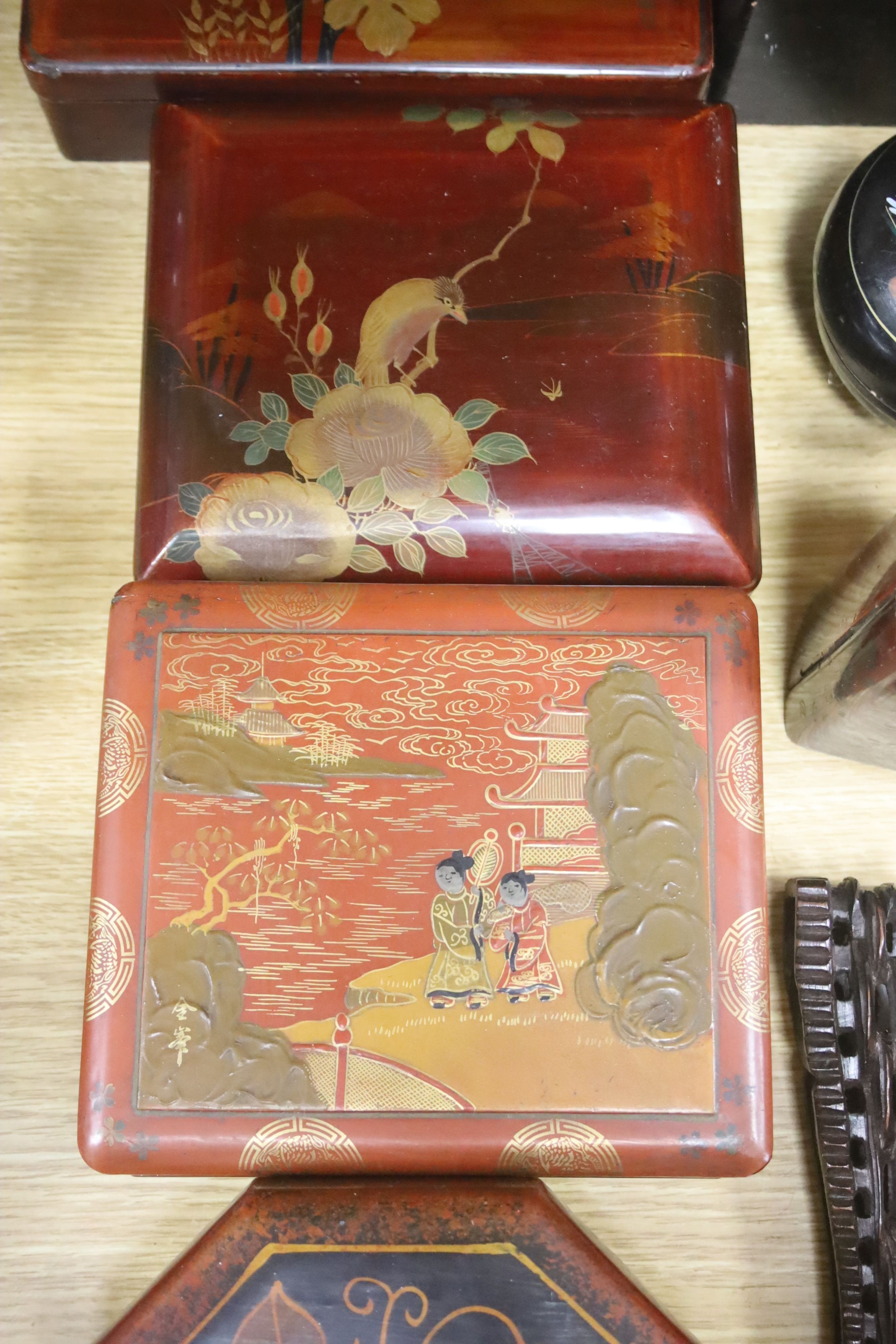 A group of Chinese or Japanese lacquer boxes and a wood stand